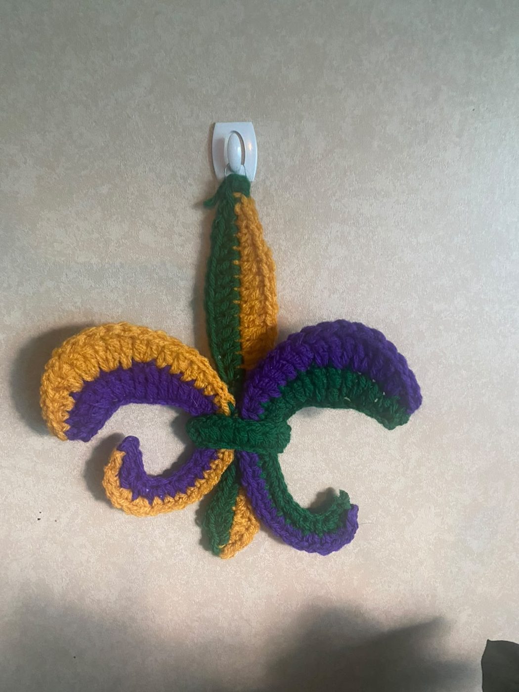 Mardi Gras Fleur-de-Lis: A purple, green and gold fleur-de-lis to hang for carnival season.
