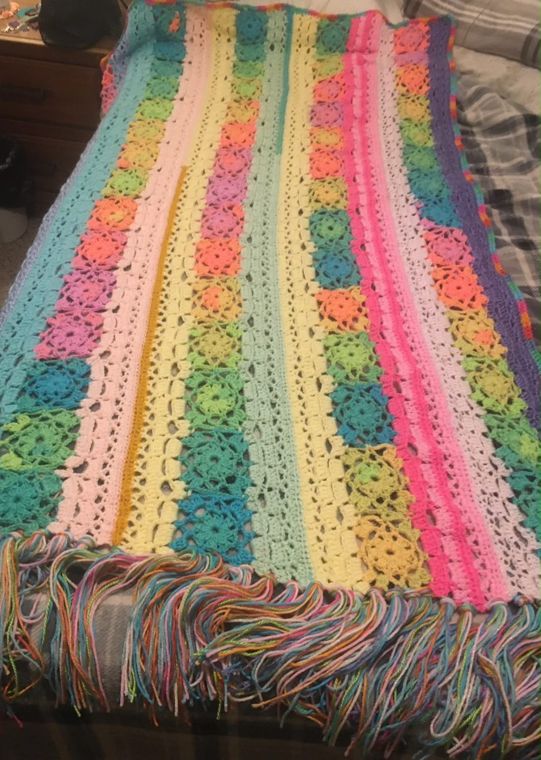 Rainbow Stripe Throw: A long throw in pastel and bright stripes with a rainbow fringe.