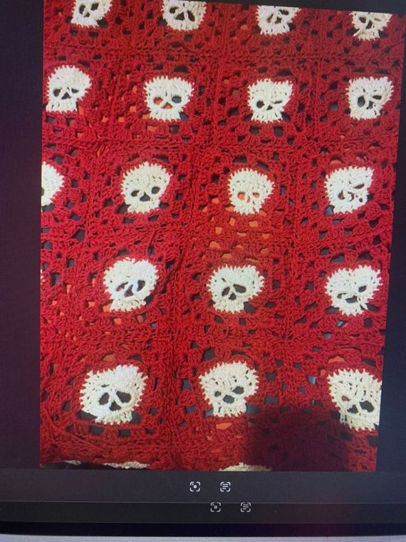 Skull Blanket: A red blanket with a cream skull in every square.
