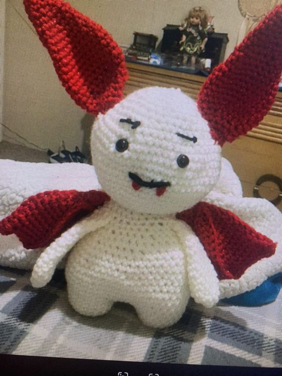 Vampire Bunny: A white plush bunny with tall red ears, a little cape and tiny fangs.